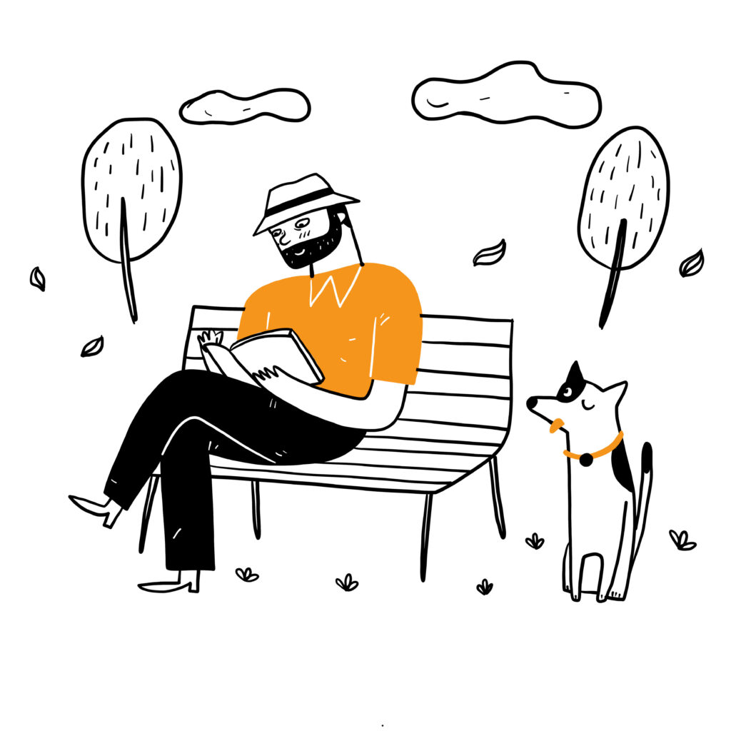 Work-life balance. A guy sitting and reading a book with his dog in a park